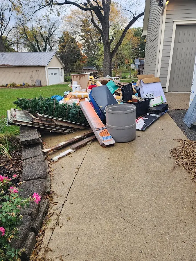 Dumpster being loaded with debris for Residential Dumpster Rental in Glencoe